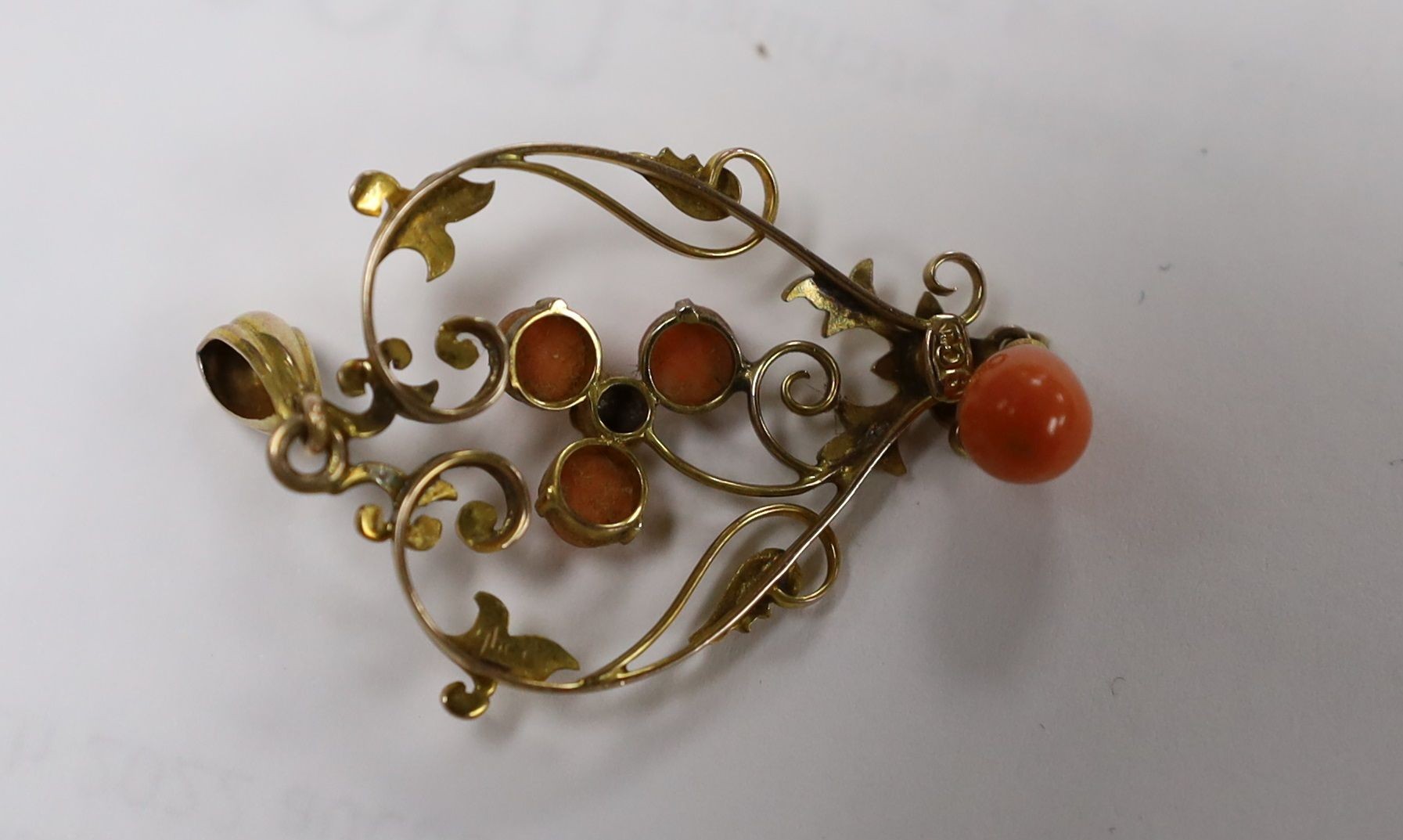 A gold and coral mounted pendant and coral earrings and a pair of amber and gold earrings